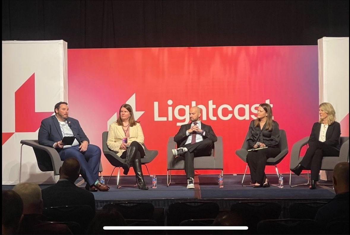 In conversation with leaders on a conference panel.